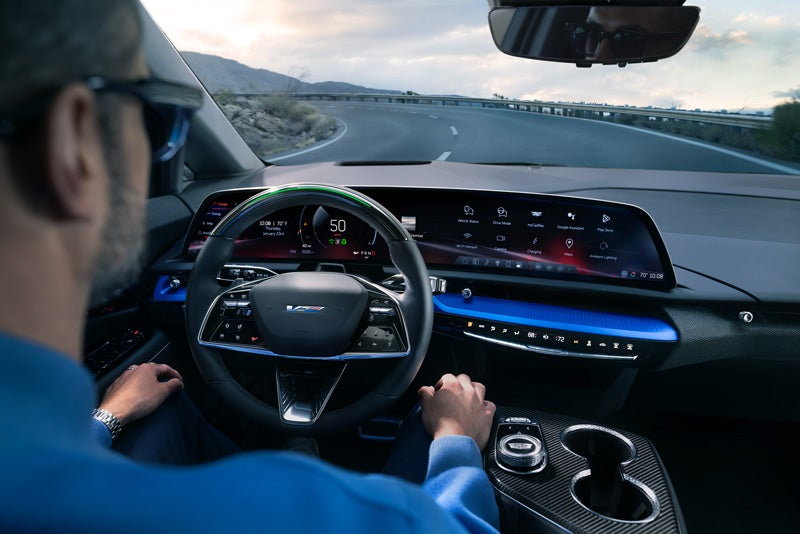 Front View of the 2026 OPTIQ-V Driving Through the Dusk Utilizing its Headlights | Ed Morse Bayview Cadillac Fort Lauderdale FL in Fort Lauderdale FL