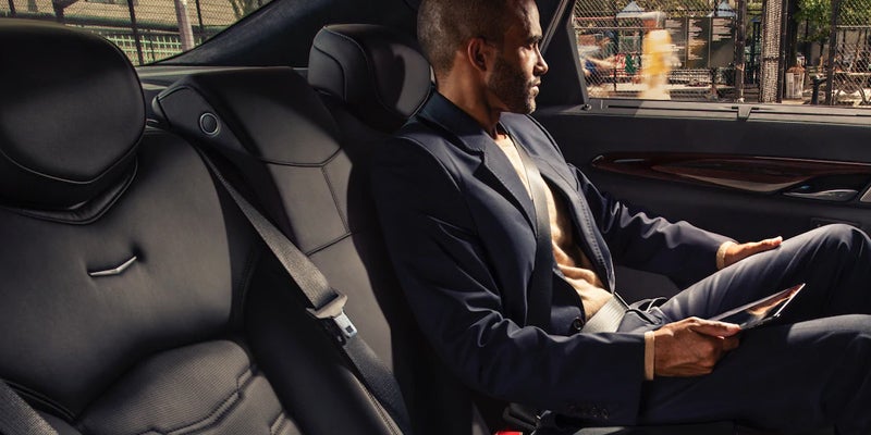 Cadillac CT6 interior - Man sitting at the window backseat of the car