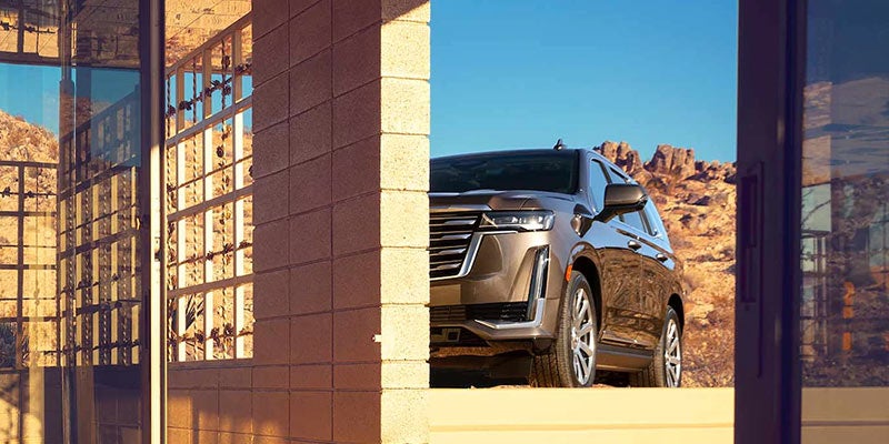 Cadillac Escalade parked next to a buiding