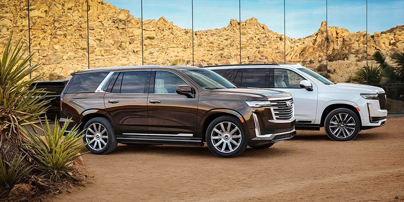 2021 Cadillac Escalade - shown two cars next to mirror in the desert