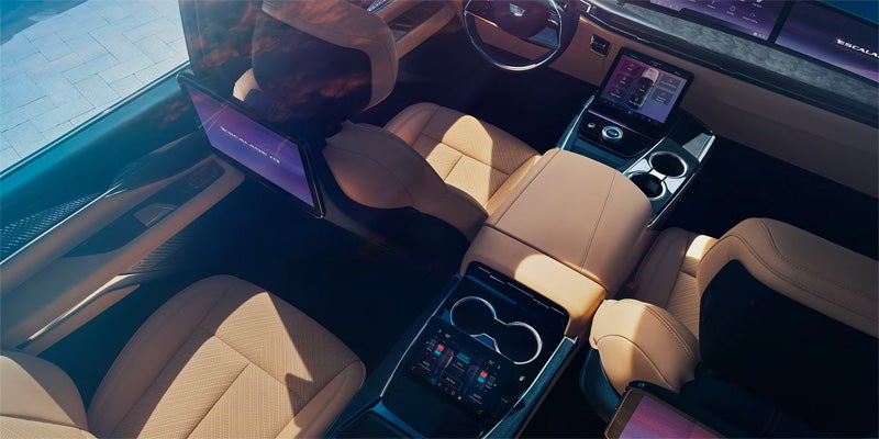 gray Cadillac Escalade IQ parked outside in the desert during dusk