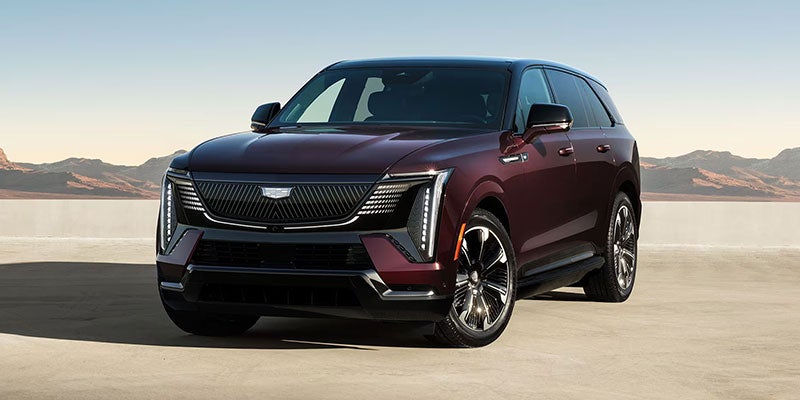 gray Cadillac Escalade IQ parked outside in the desert during a sunny day