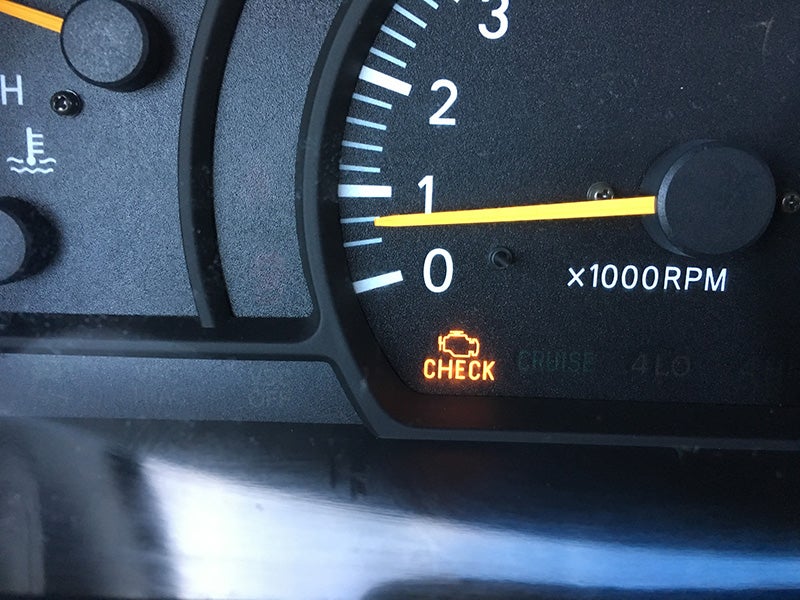 Check engine light on the dashboard for a Cadillac vehicle